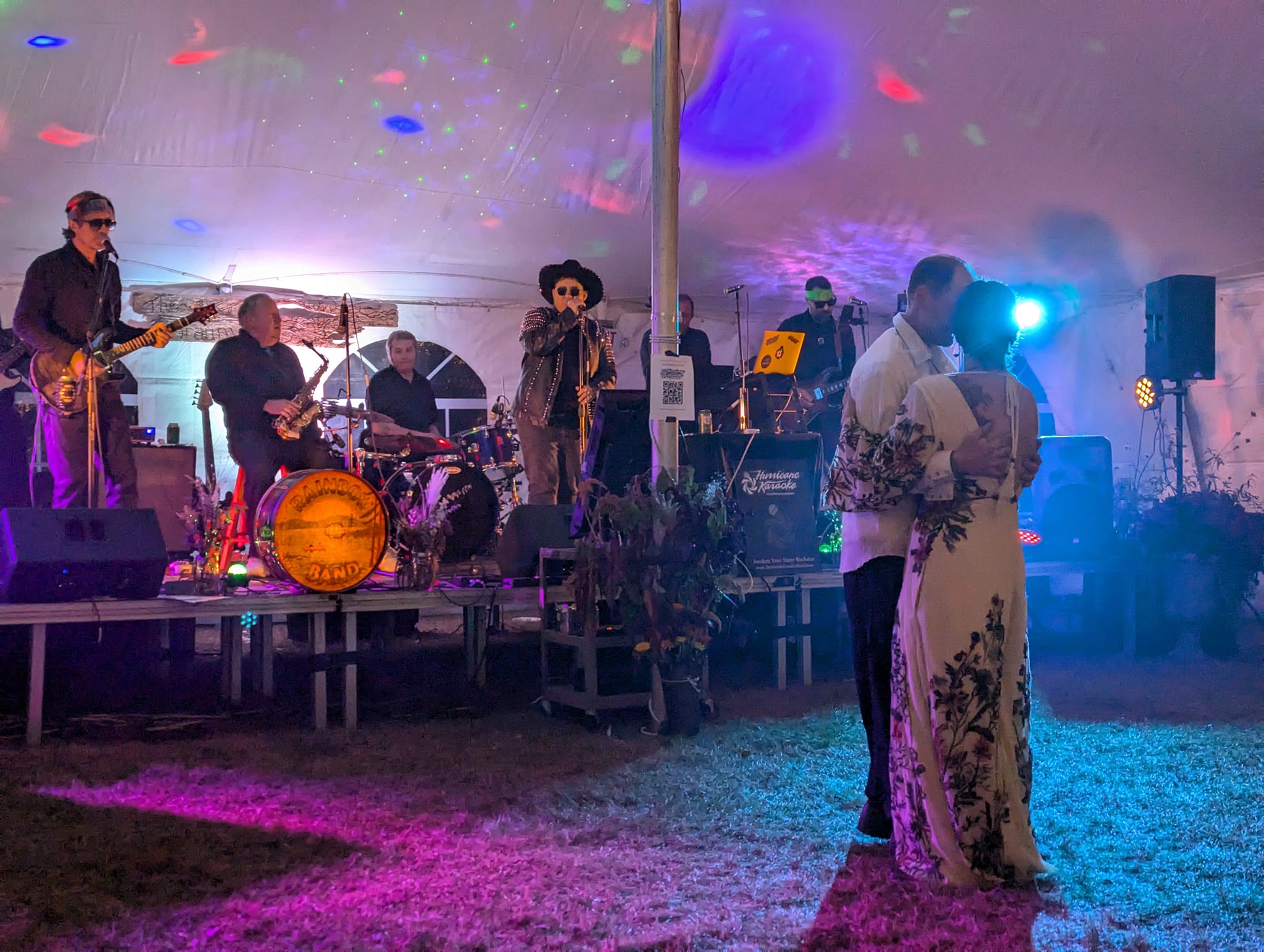 bride and groom dancing at a wedding with a band in the background