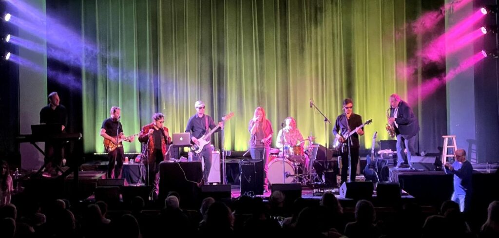 band performing on stage in a theater